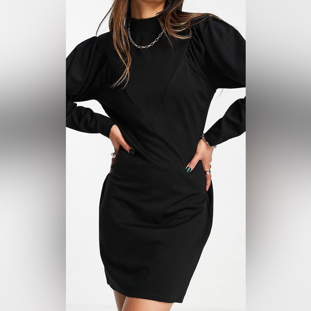 •High neck , Volume sleeves, shoulder pads.